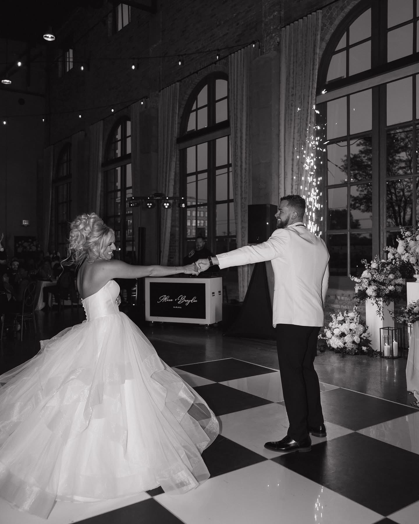 Alexa and Braydon dancing beneath cold sparks inside The Steam Plant
